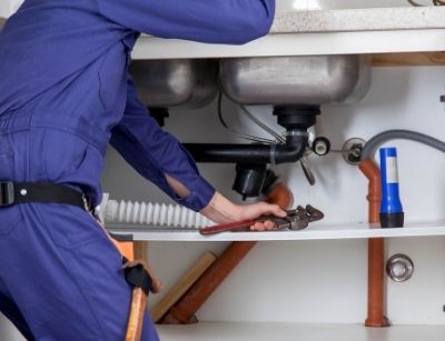 someone performing drain cleaning