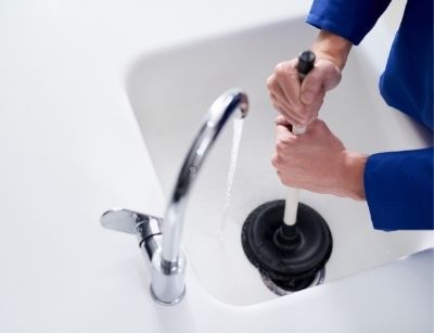 someone plunging a drain